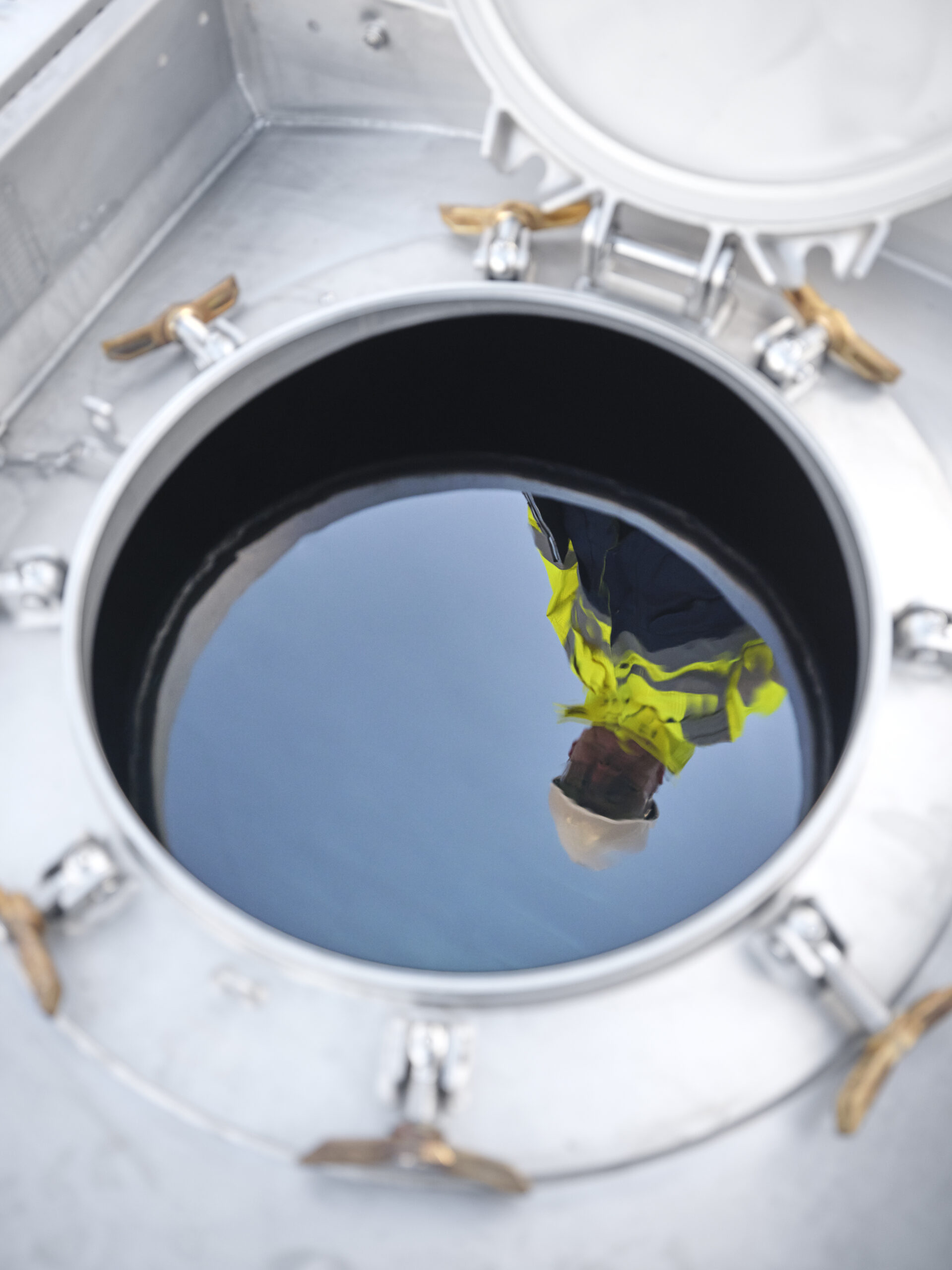 reflection-of-technician-in-manway-with-water-scaled