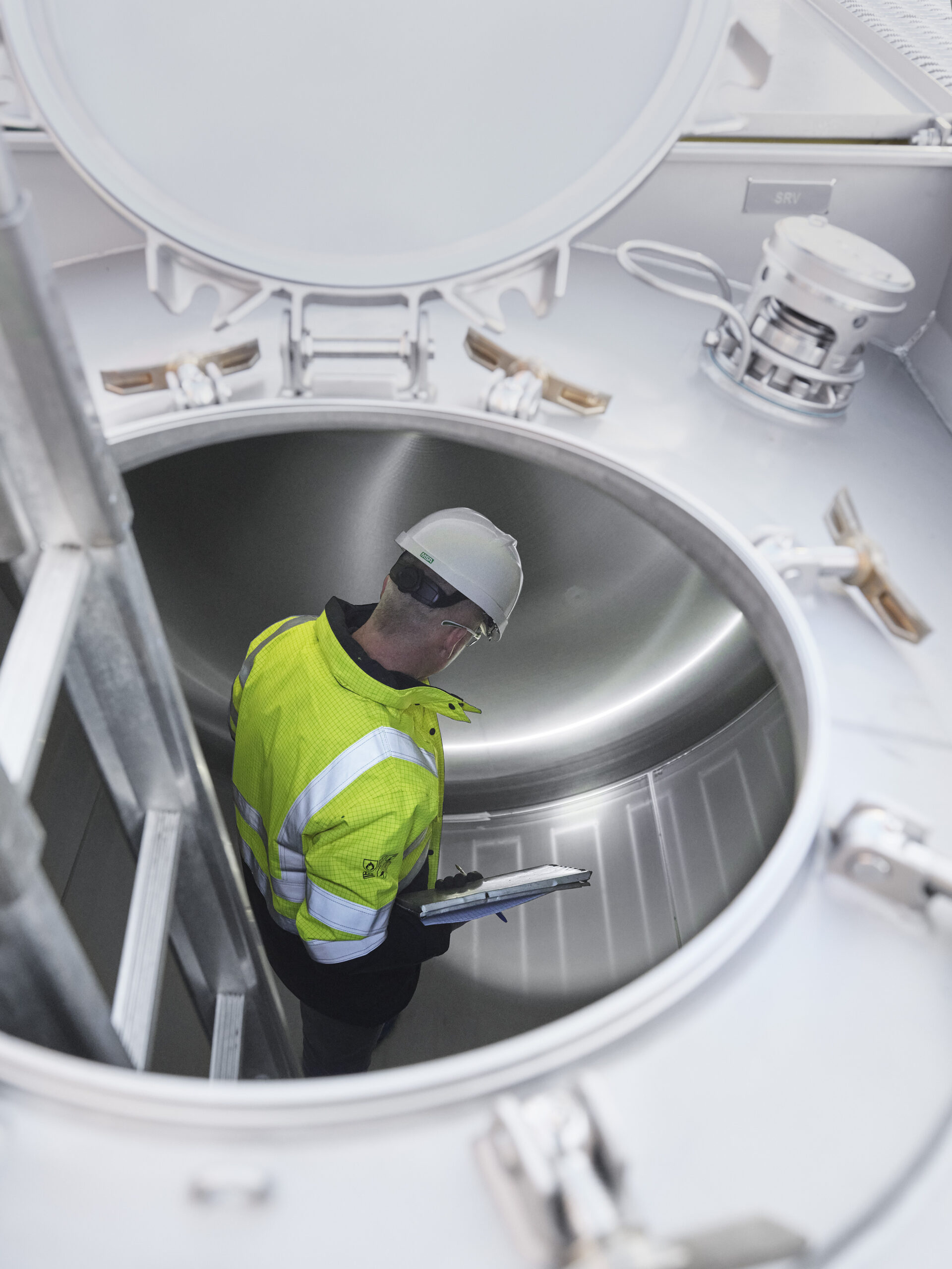 technician-in-tank-view-through-manway-scaled